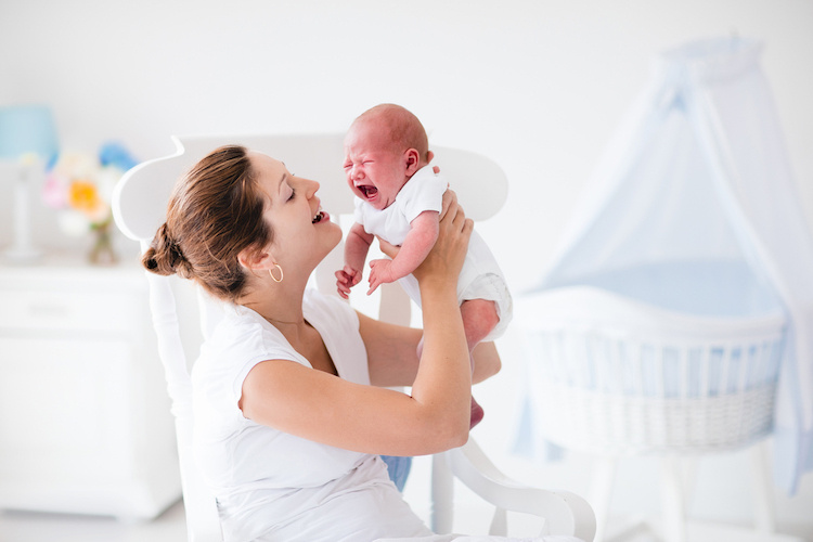 Mom trying to calm a crying newborn