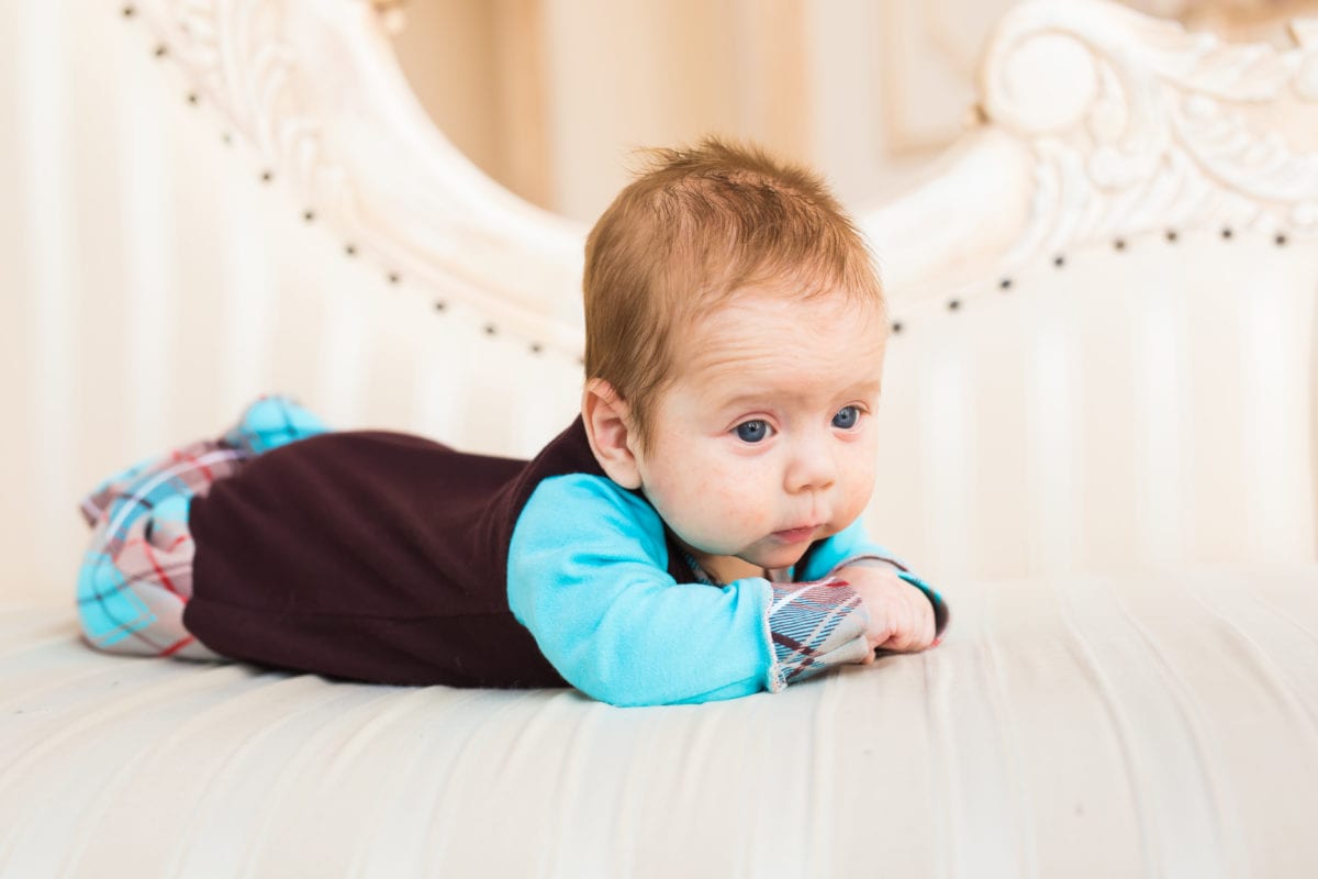 Adorable baby boy with red hair and blue eyes. Newborn child lying in couch. 30 Irish-Inspired Baby Names for Boys and Girls