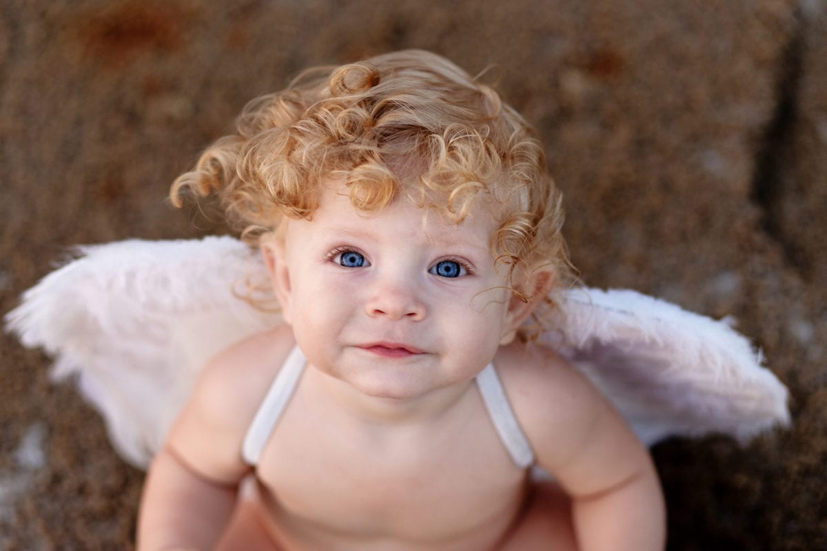 Curly haired boy with angel wings 30 Irish-Inspired Baby Names for Boys and Girls