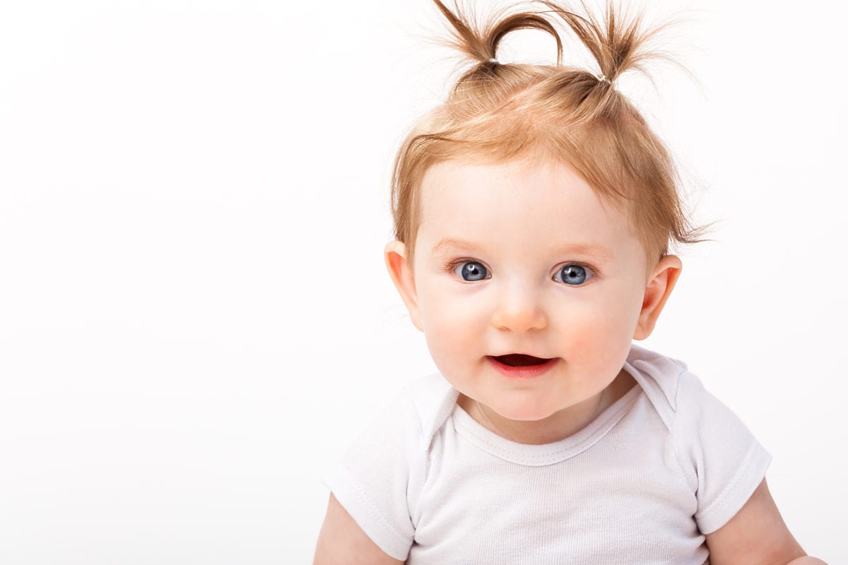 Baby girl with two pig tails on her head 30 Irish-Inspired Baby Names for Boys and Girls