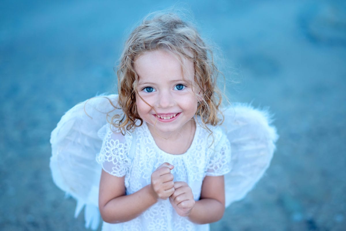 Smiling girl with angel wings 30 Irish-Inspired Baby Names for Boys and Girls