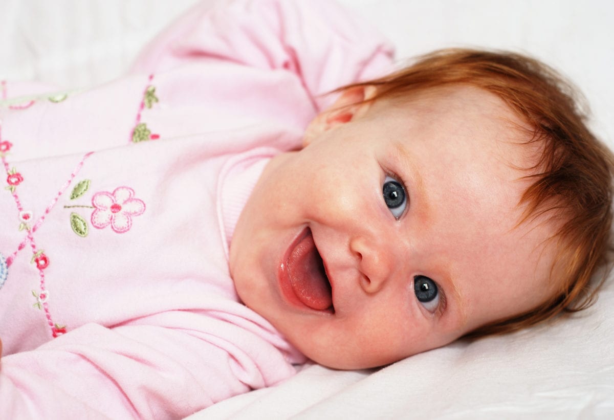 Smiling red haired baby girl 30 Irish-Inspired Baby Names for Boys and Girls