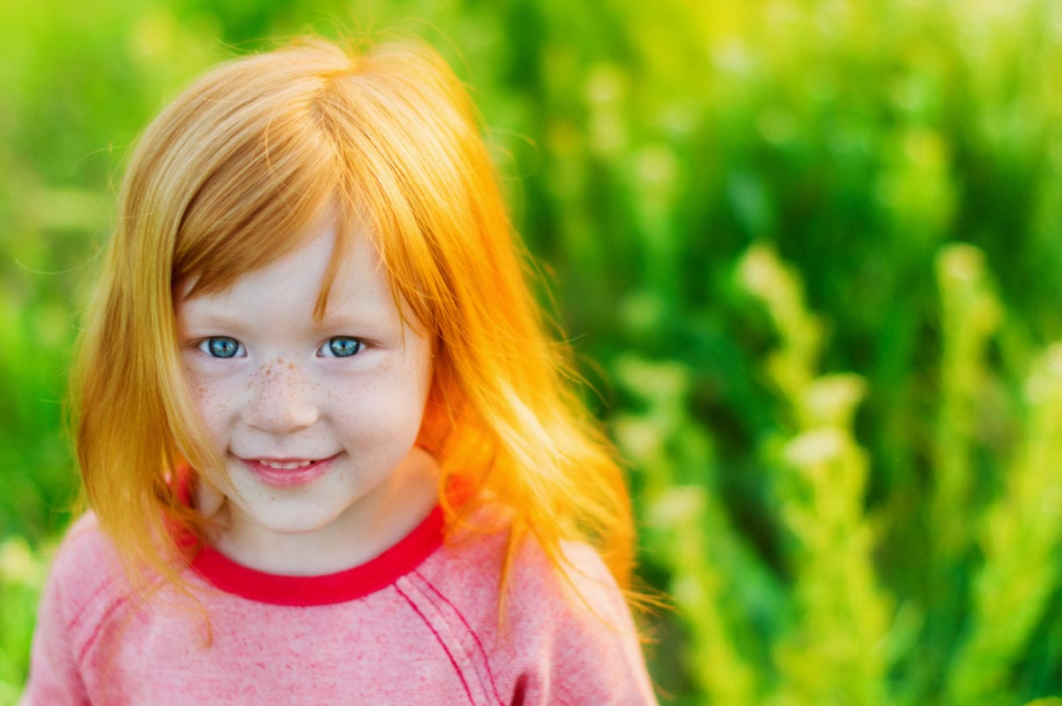 Red haired blue eyed girl in field 30 Irish-Inspired Baby Names for Boys and Girls