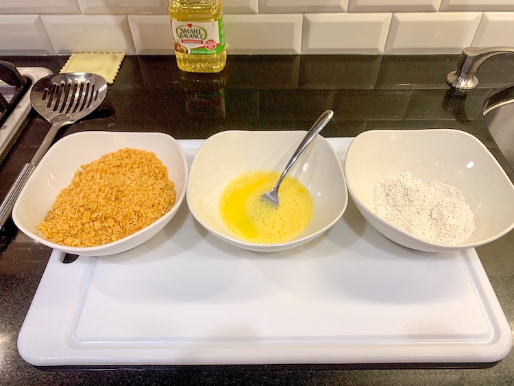 Jennifer Garner's Crispy Fish Sticks Recipe Batter Station with three bowls - one flour, one egg and one breadcrumbs