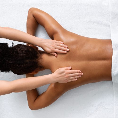 Slim,Black,Woman,Receiving,Full,Body,Massage,At,Modern,Spa,